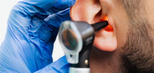 Doctor examining patient's ear