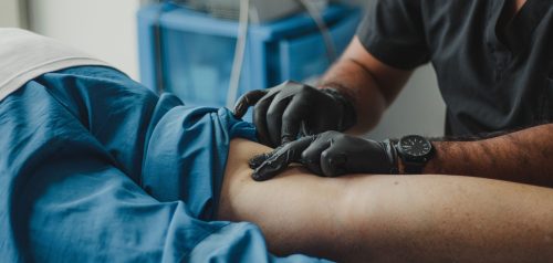 Healthcare professional treating patient's arm