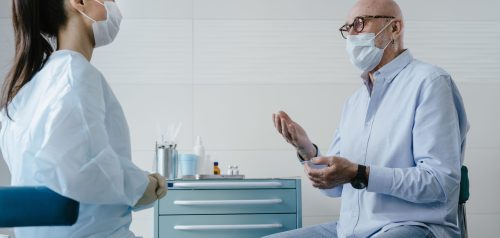 Older patient speaking with doctor